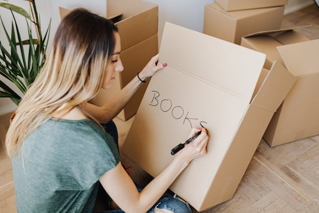 Content woman writing on cardboard container word book